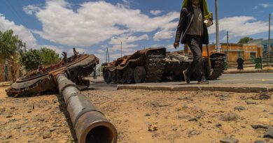 Wikipedia: A man passes by a destroyed tank on the main street of Edaga Hamus, in the Tigray region, in Ethiopia, on June 5, 2021.