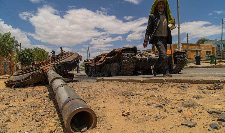 Wikipedia: A man passes by a destroyed tank on the main street of Edaga Hamus, in the Tigray region, in Ethiopia, on June 5, 2021.